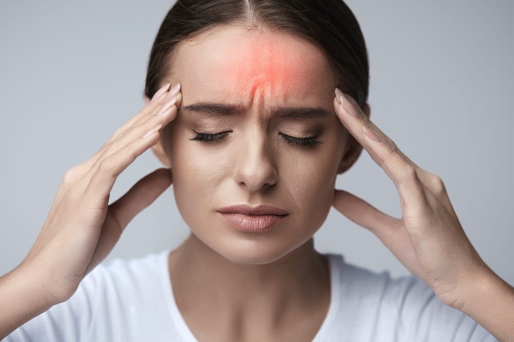 a woman suffering from headaches